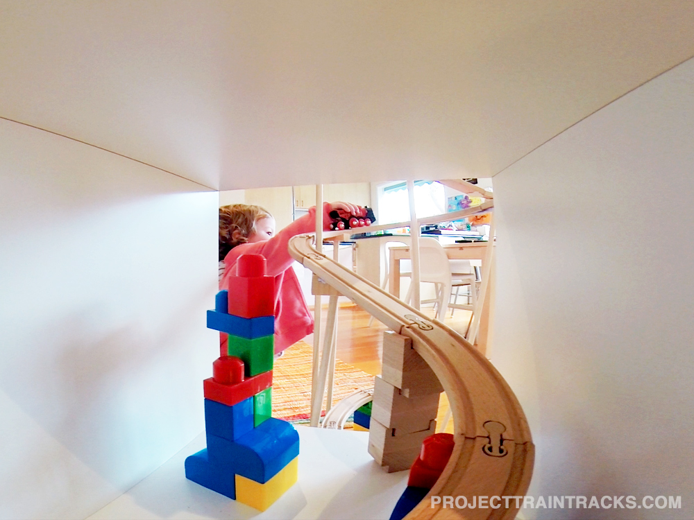 Toddler playing with train set and brio engine 